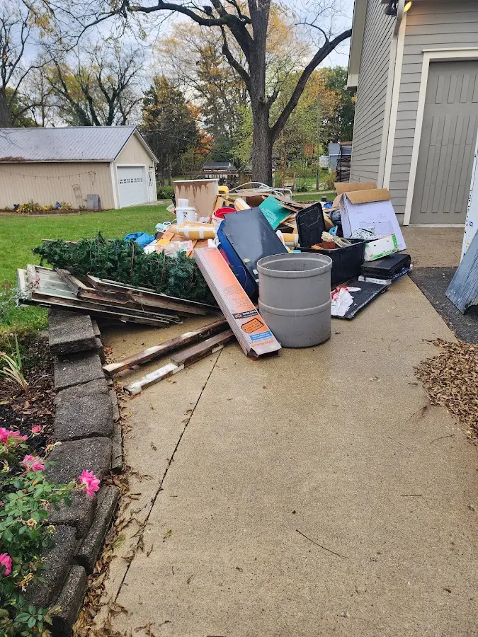 Dumpster being loaded with debris for 12 Yard Dumpster Rental in Magalia